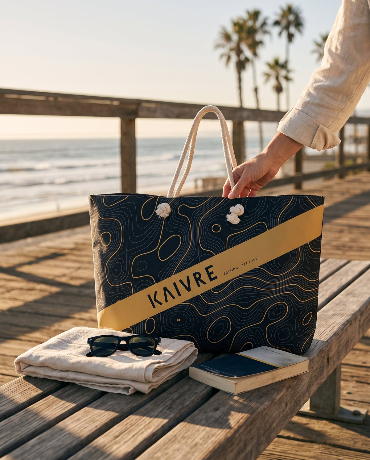 The Tide Lines Weekender on a boardwalk bench by the ocean